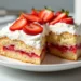 A finished strawberry poke cake topped with whipped cream and fresh strawberries, perfect for your beginner-friendly Strawberry Poke Cake Recipe.