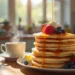 Your delicious stack of golden Pancakes From Scratch topped with fresh berries and syrup